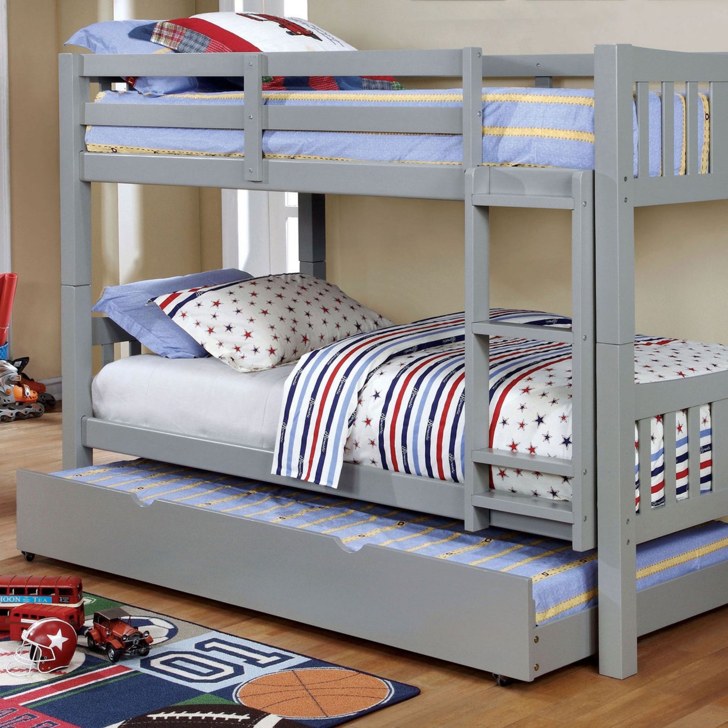 Full over full bedframe bunkbed in light gray veneer with bottom roll out twin trundle in bedroom setting
