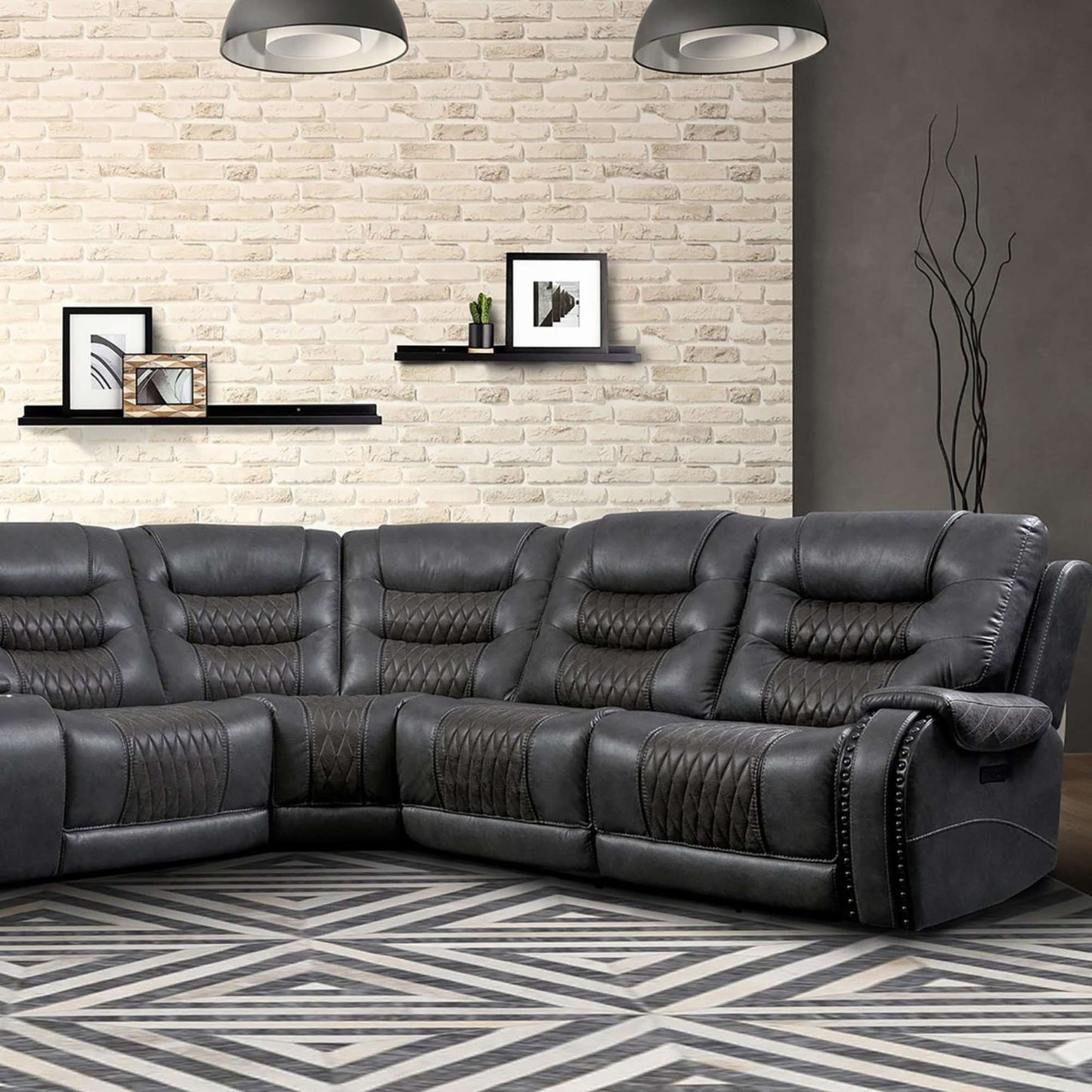 Gray sectional sofa in a living room with a patterned wall and floor.