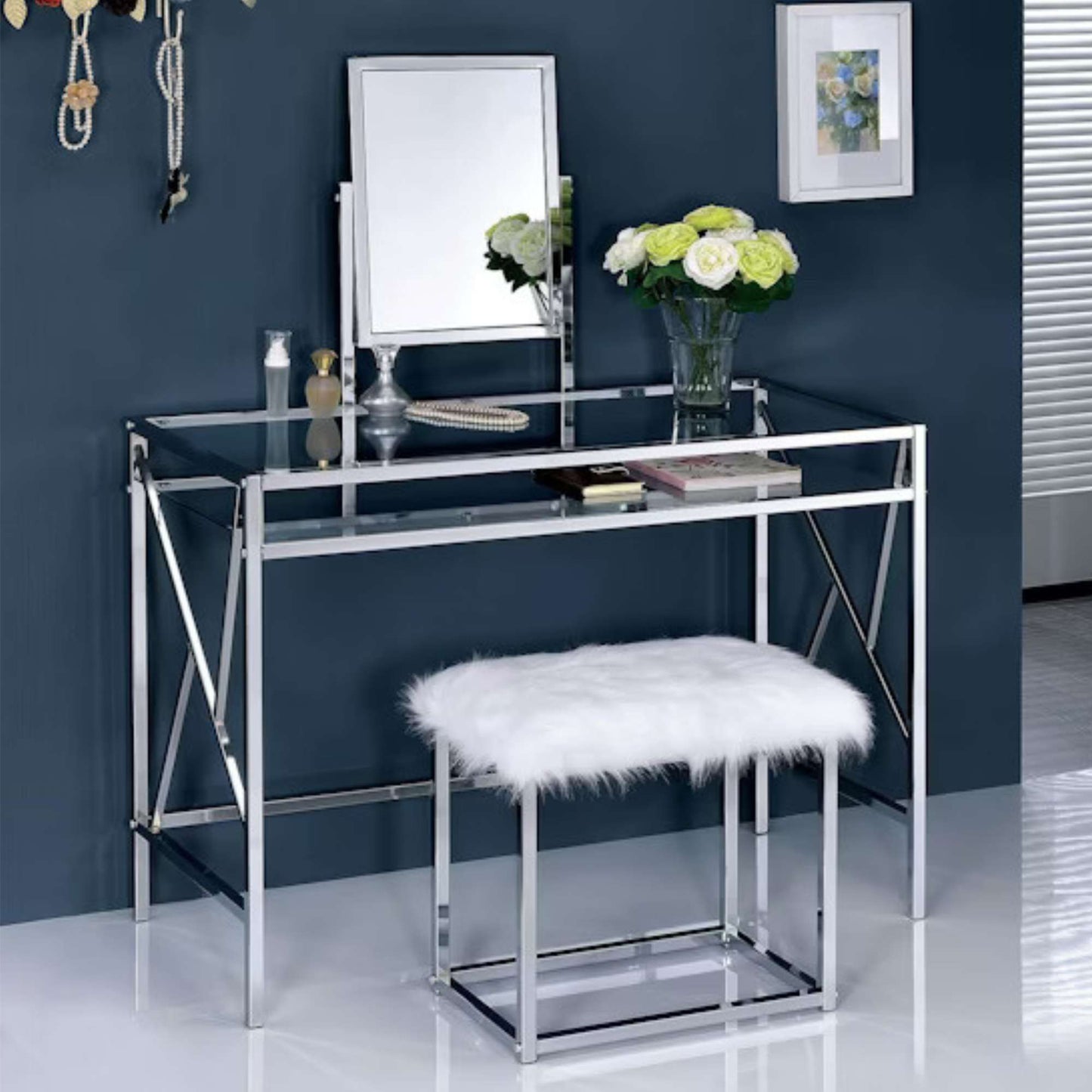 Dressing table with mirror, stool, and decorative items against a blue wall.