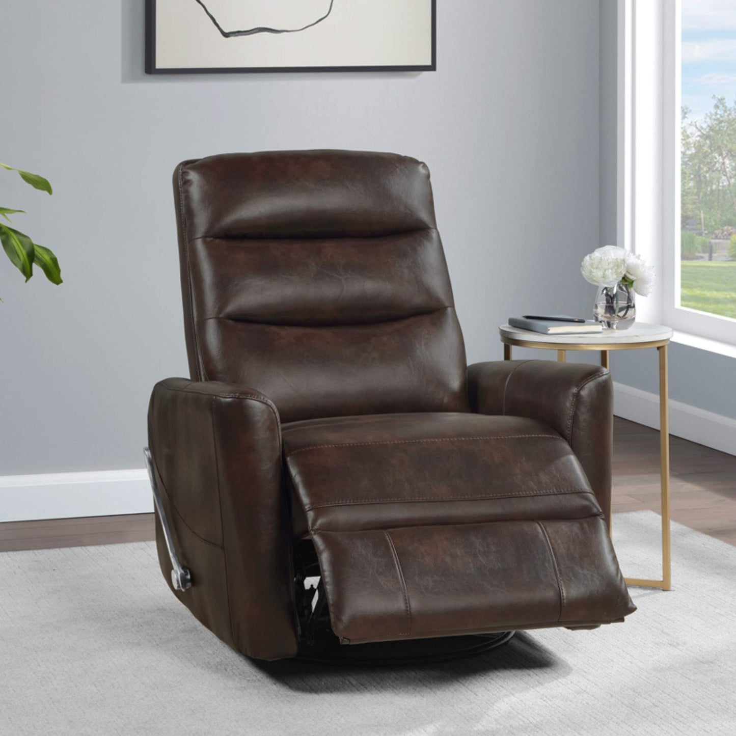 A brown faux leather glider swivel recliner chair with its footrest extended, placed in a room with a white wall and a decorative plant in the background.