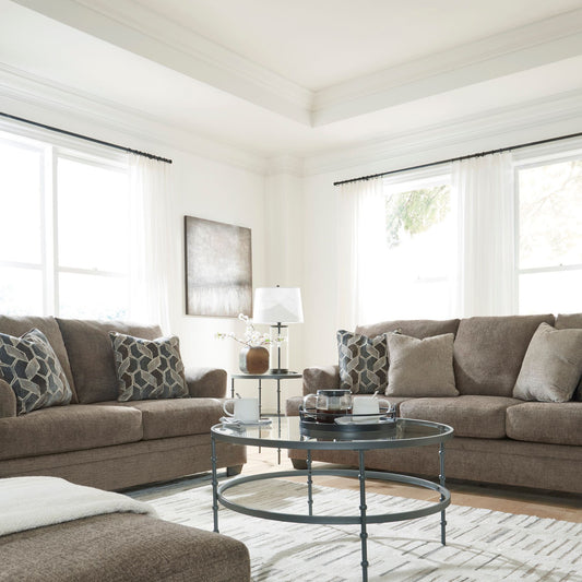 Living room with Borgoe brown loveseat and sofa set, coffee table, and decorative pillows.