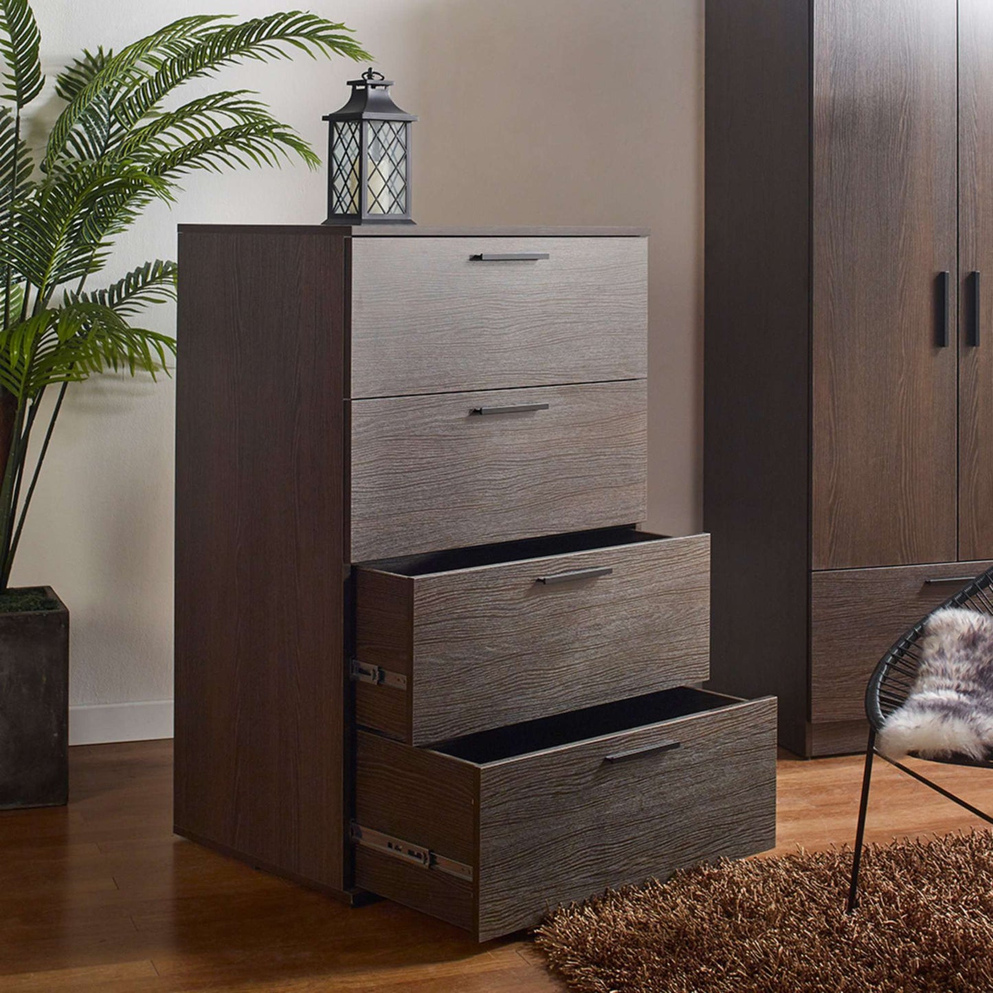 Camy dark brown four drawer chest with extension gliders in bedroom setting