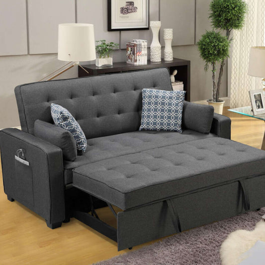 Gray sofa bed in a living room setting with pillows and a small table.