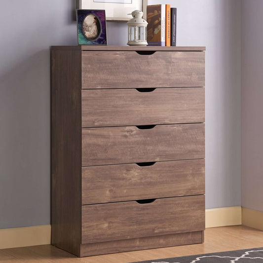 Wooden dresser with four drawers against a gray wall.