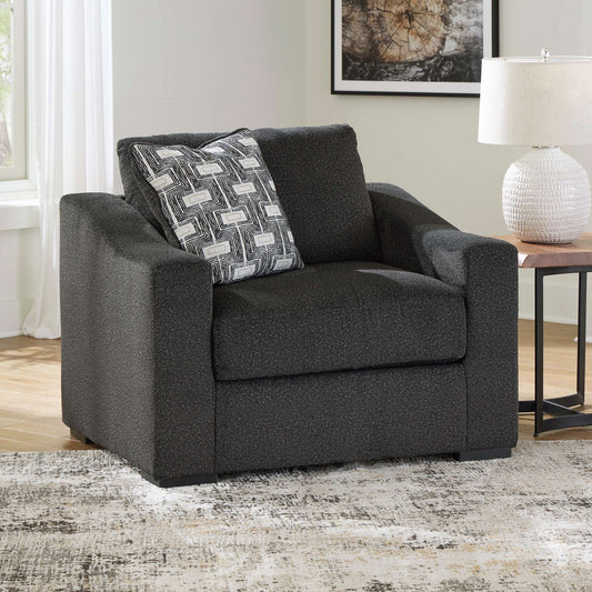 Daron oversized chair and a half in onyx upholstery with patterned accent pillow in living room setting
