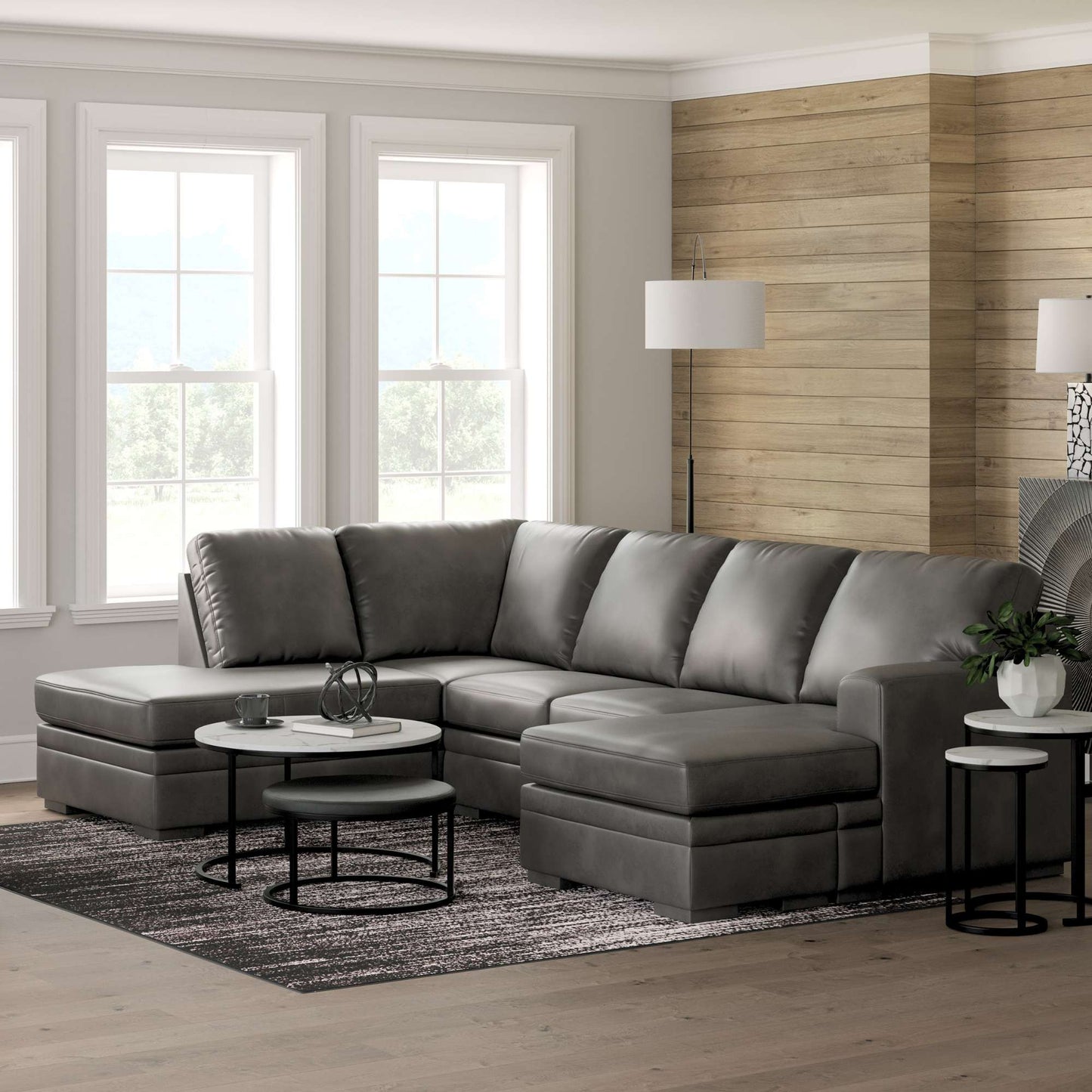 Devlin Shadow Gray sectional with Double Chaise in a living room with wooden walls and a occasional tables.