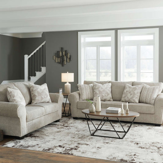 Elisende sofa and loveseat in sisel upholstery with accent pillows in living room setting