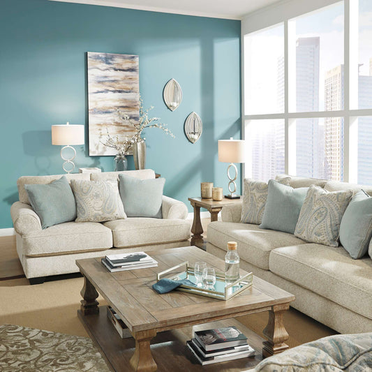 Living room with beige sofa, wooden coffee table, and blue walls.