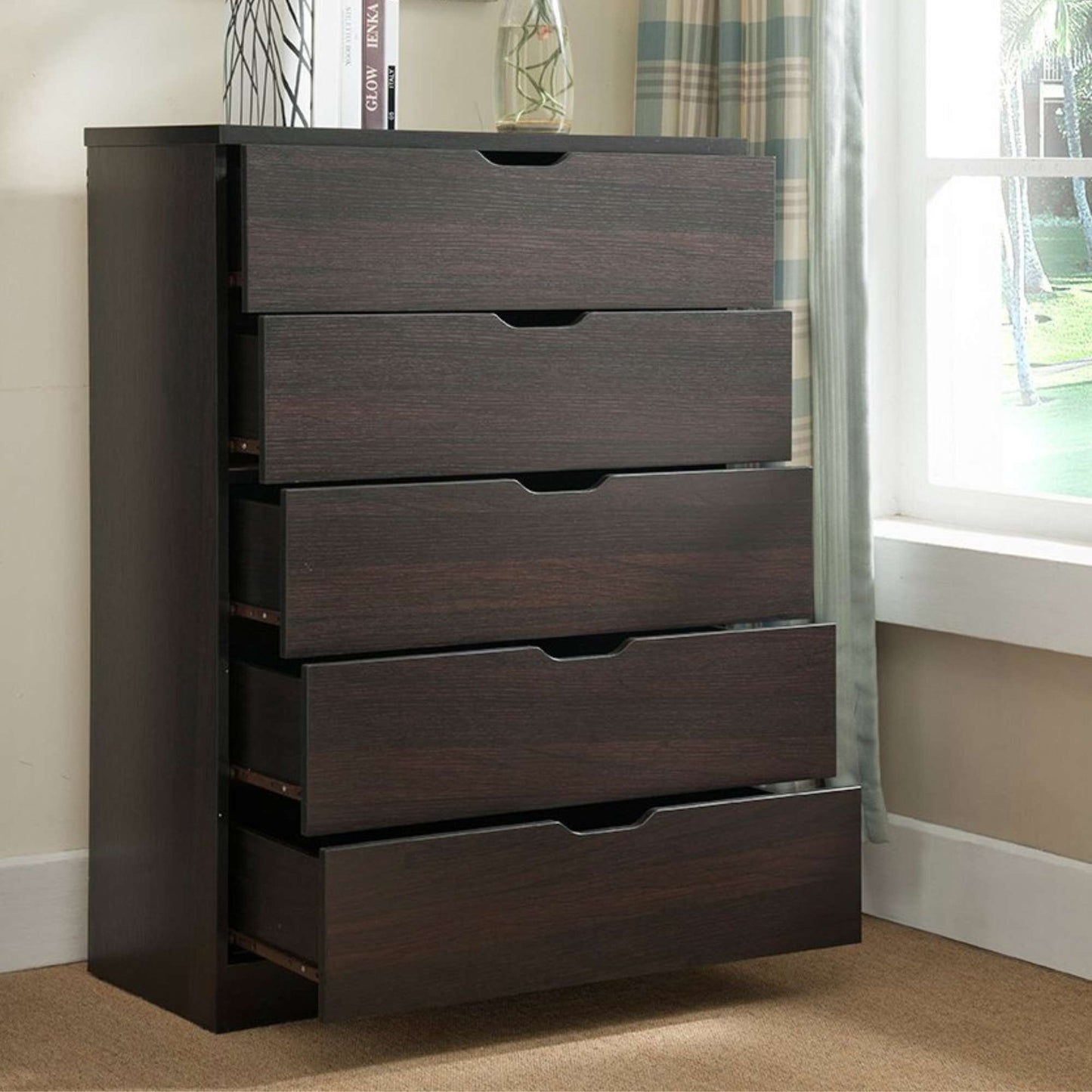Dark wood dresser with four drawers in a room setting.