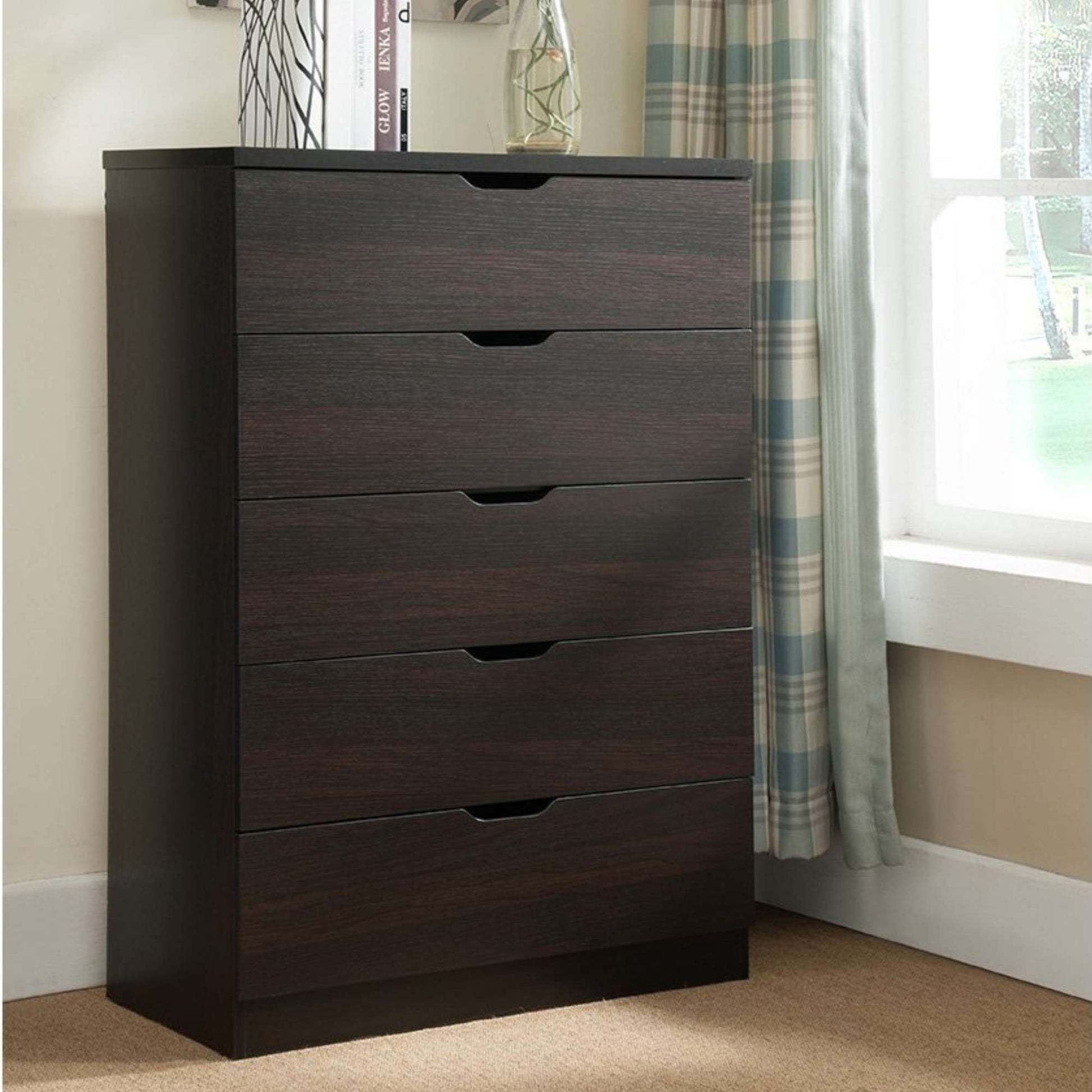 Dark wood dresser with multiple drawers in a room with a window and curtains.