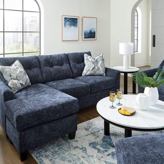 The contemporary Galen sofa chaise available in navy upholstery with accent pillows included in a living room setting