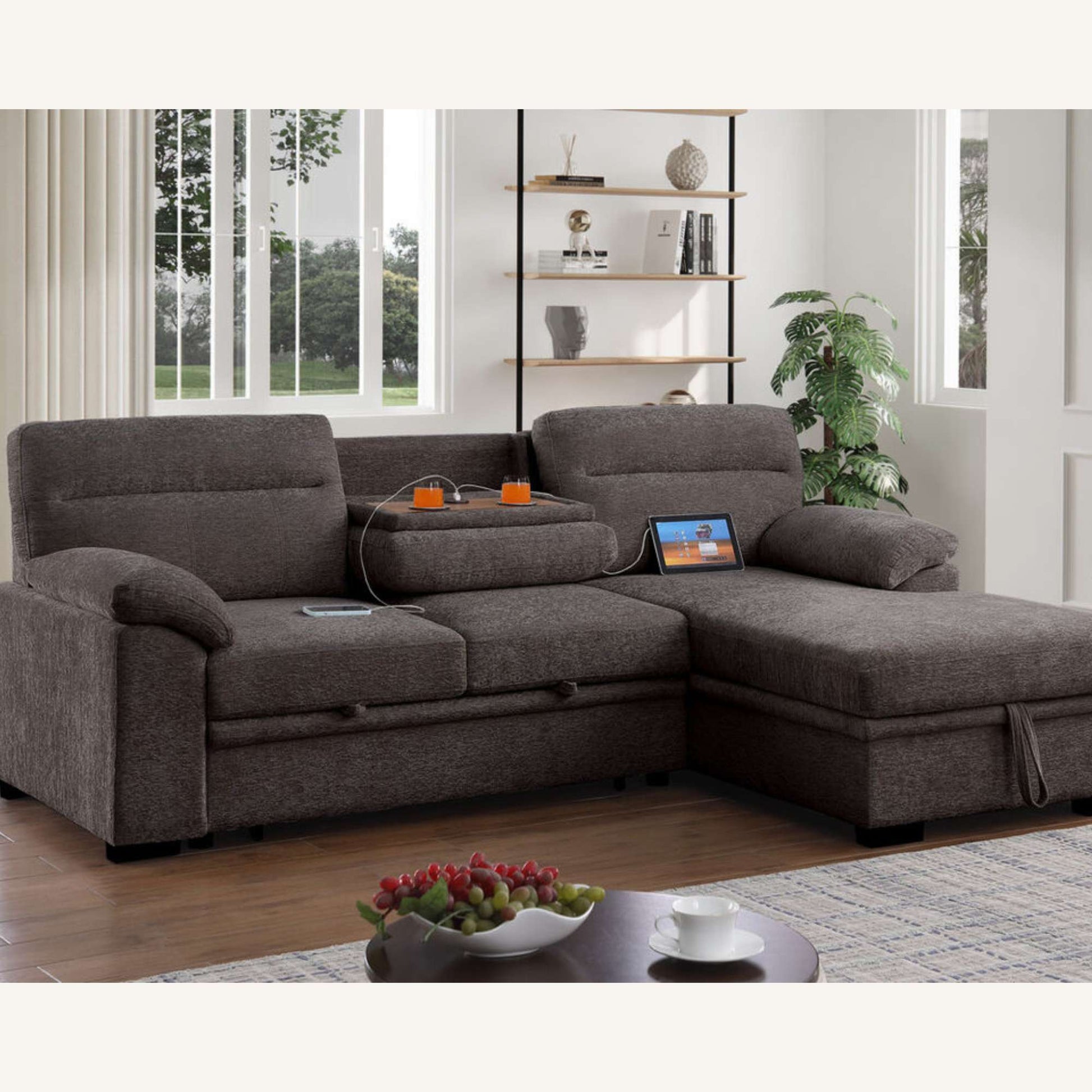 Gray sectional sofa in a living room with a coffee table and decorative items.