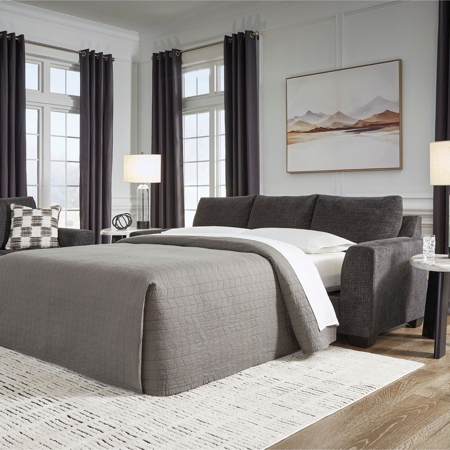 Gorgius sofa sleeper with queen size memory foam mattress in living room setting with bed covers. 