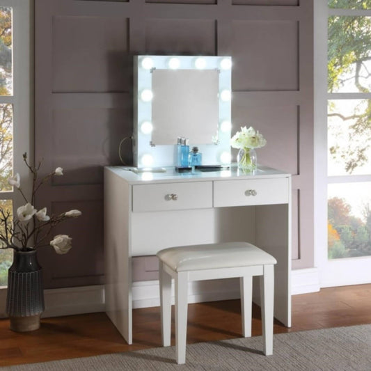 White Heartley vanity table with mirror and stool in a room with large windows.