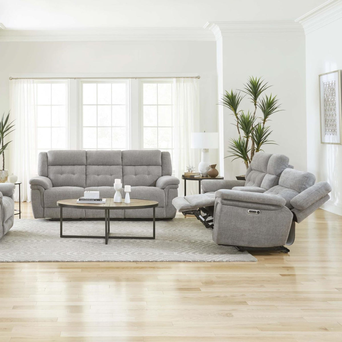 Jilly Power Reclining Sofa and Loveseat with Power Adjustable Headrest in living room setting with home decor accents
