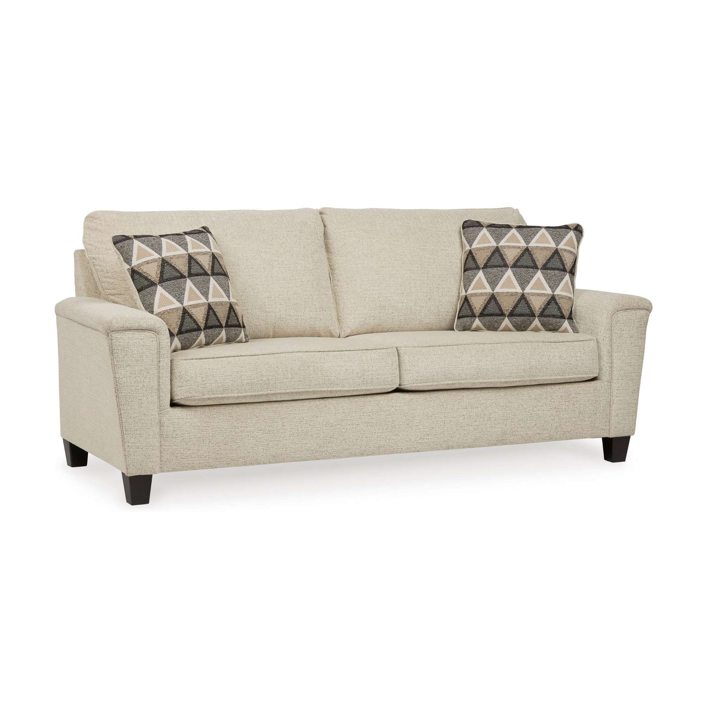 Beige sofa with two patterned throw pillows on a white background