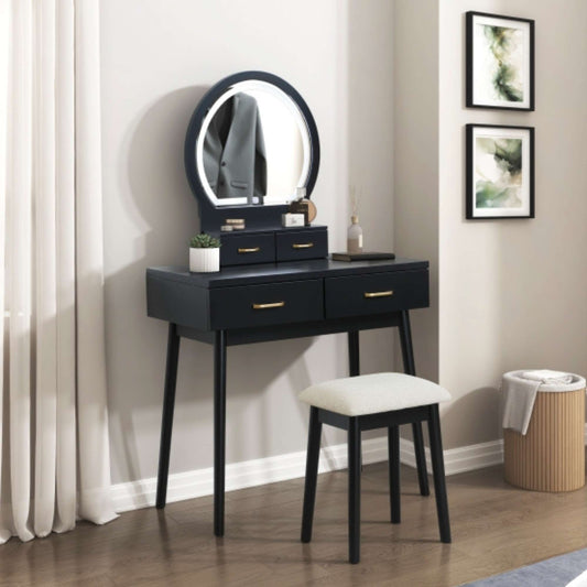 Black vanity table with round mirror and stool in a room setting