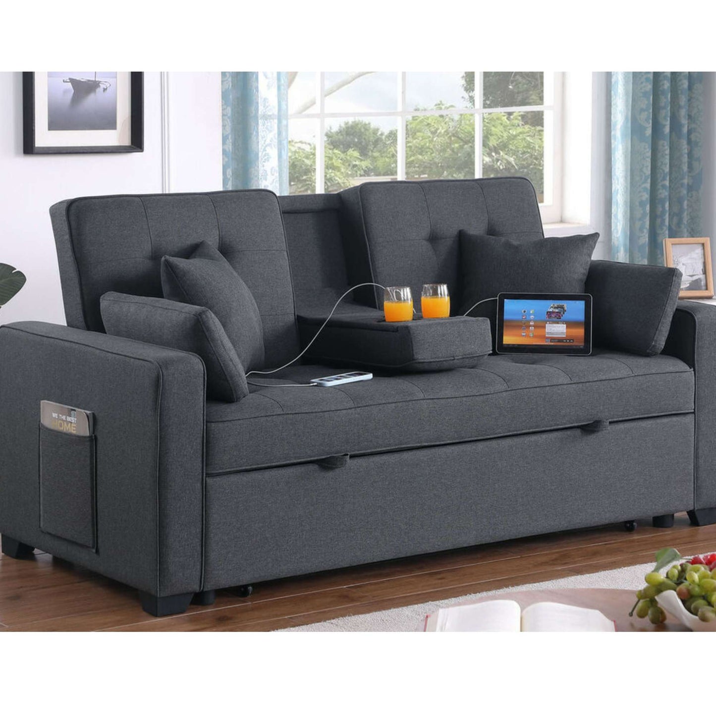 Montia Gray sofa with cup holders, remote controls, and a tablet in a living room setting.