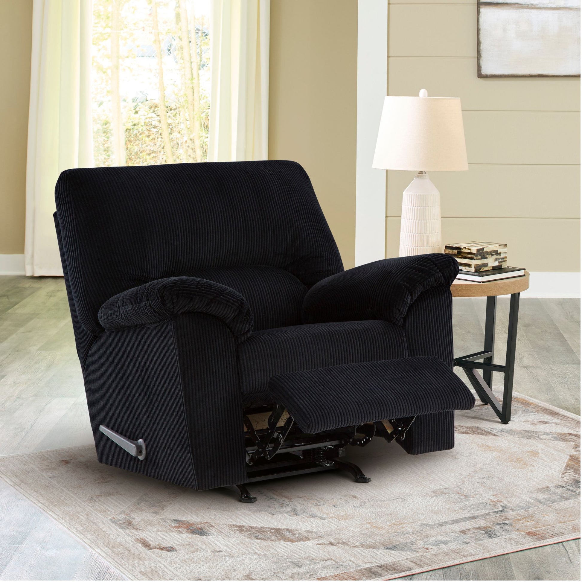 Open Orevis onyx corduroy upholstered rocker recliner chair in living room setting