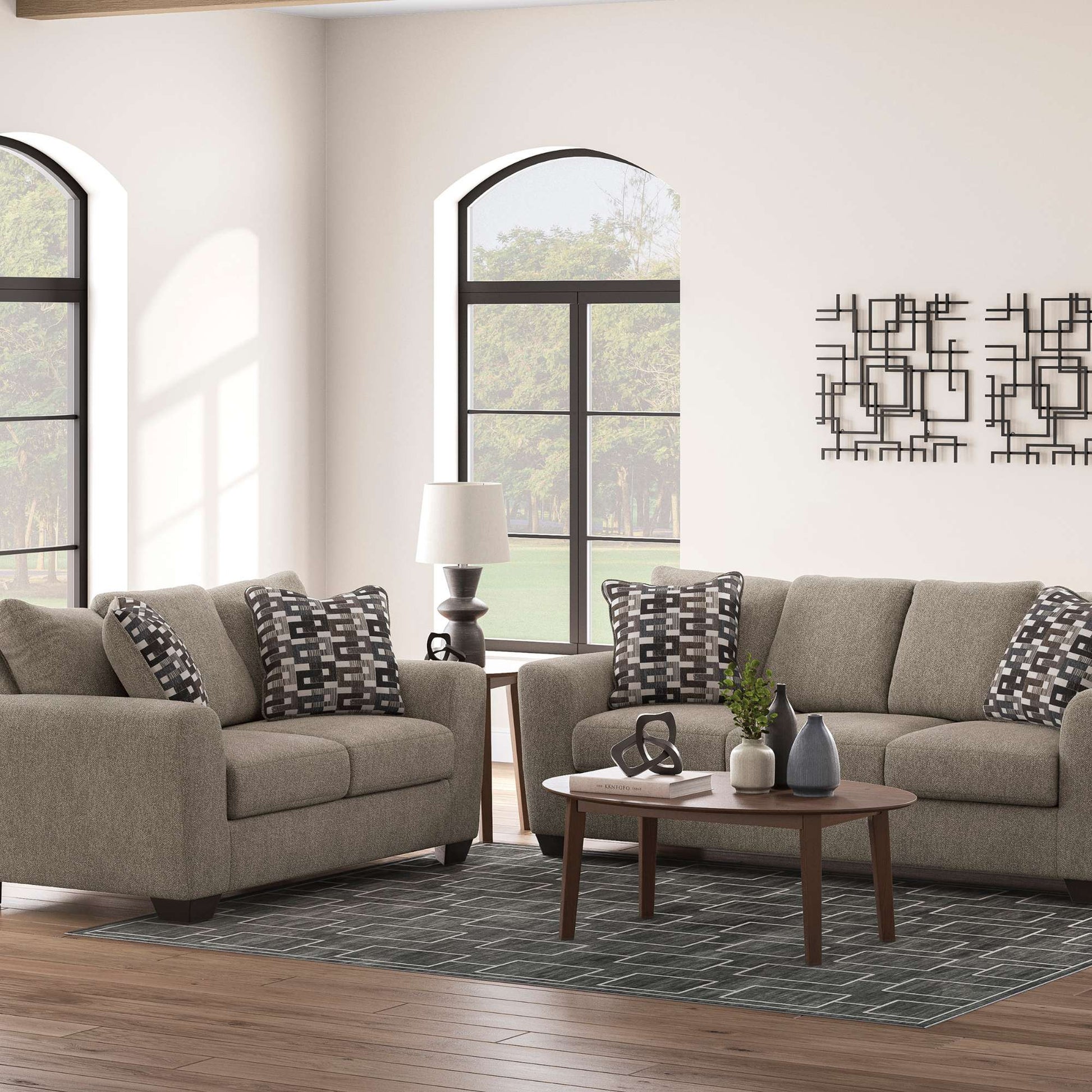 Living room setting with Orla sofa and loveseat set with accent pillows and decorative pieces. 