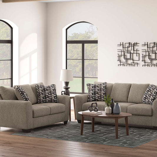 Living room setting with Orla sofa and loveseat set with accent pillows and decorative pieces. 
