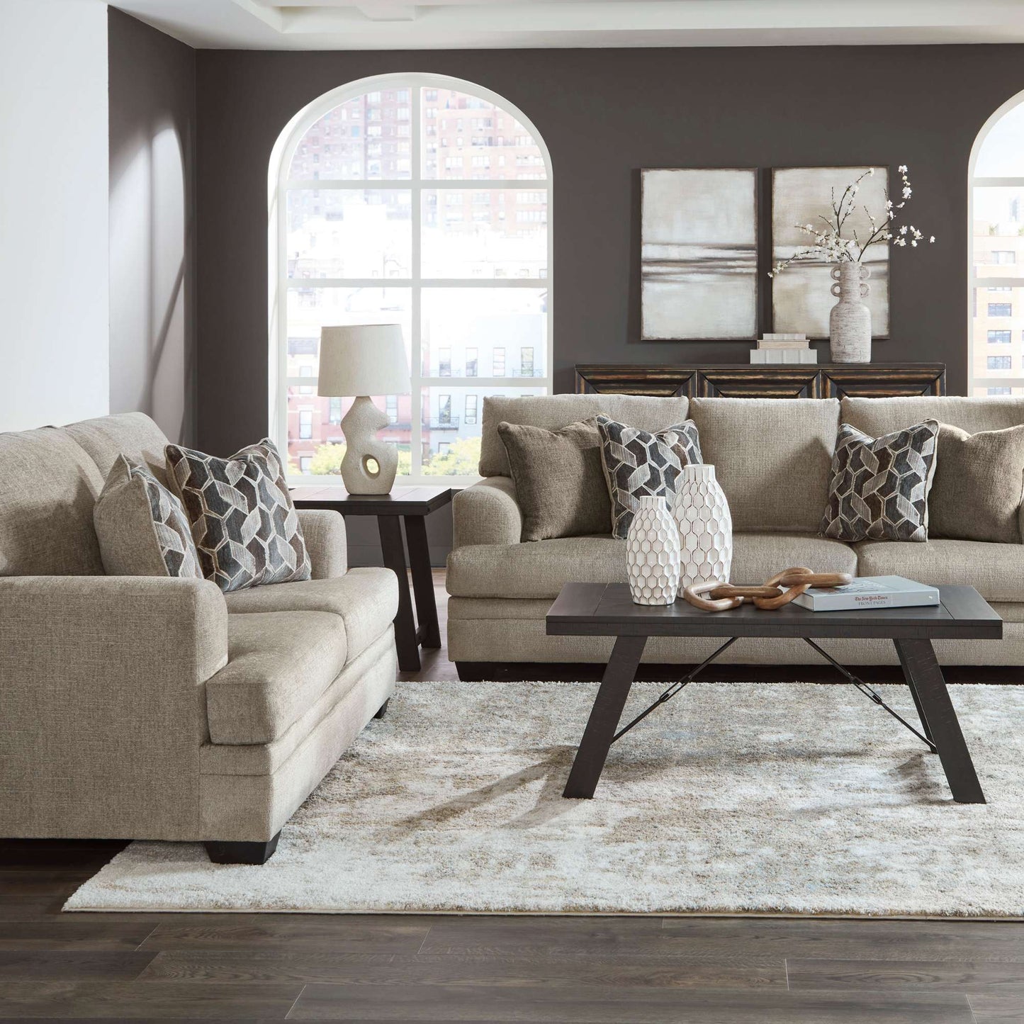Pittman taupe sofa and loveseat set in living room setting 