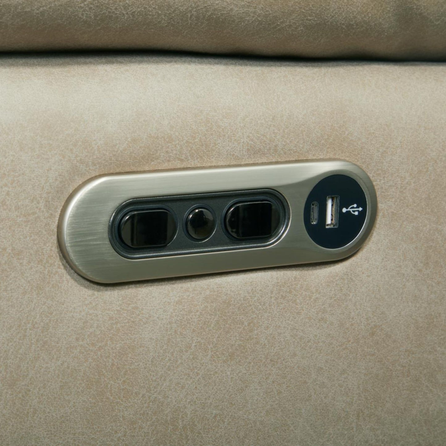 A close-up of a Porerto side controls in brushed metal power outlet panel with a USB port, mounted on  tahoe fog textured fabric surface.