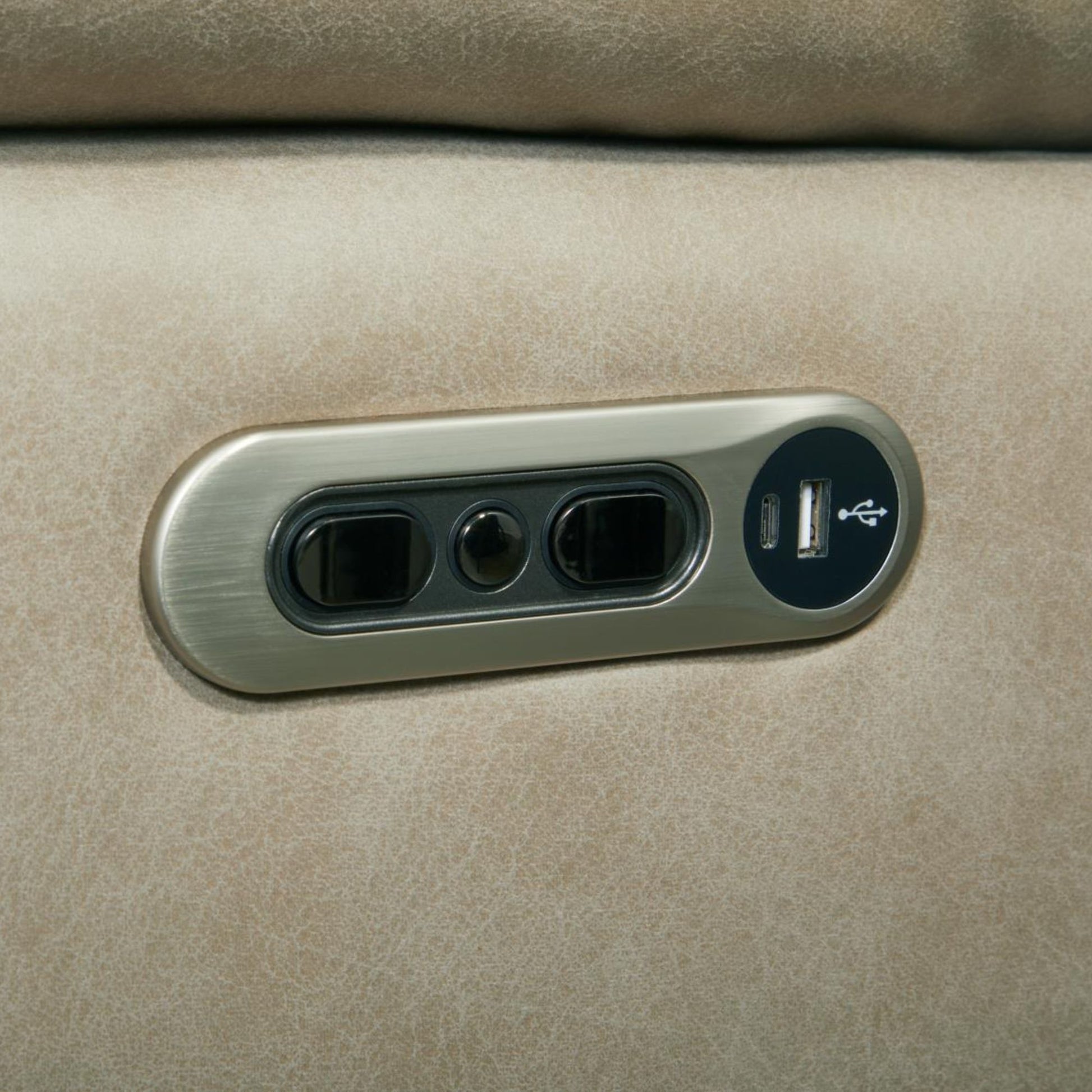 A close-up of a Porerto side controls in brushed metal power outlet panel with a USB port, mounted on  tahoe fog textured fabric surface.