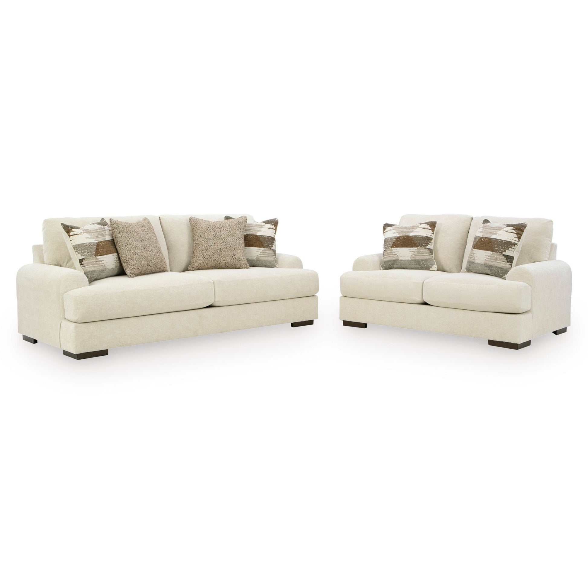 Sarabi sofa and loveseat set in sand upholstery with neutral multi-colored accent pillows on white background