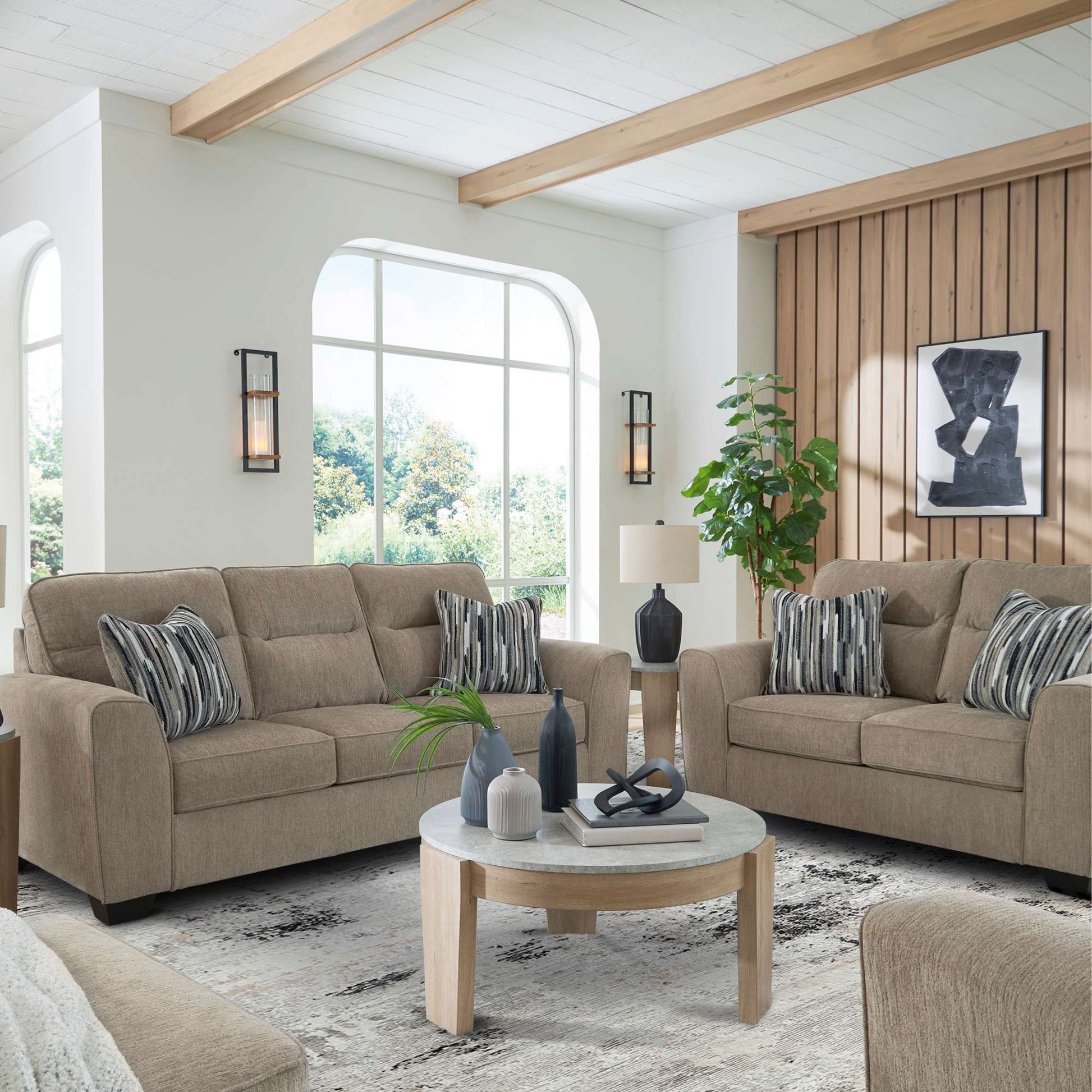 Wingfield sofa and loveseat set in mocha upholstery with accent pillows in living room setting